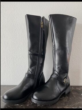 Black leather knee-high boots with buckle detail